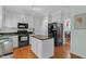 Well-equipped kitchen with white cabinets, a center island, modern appliances, and convenient layout at 6245 Hampton Ridge Rd, Raleigh, NC 27603