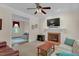 Cozy living room showcasing a brick fireplace, mounted TV, and comfortable seating, perfect for relaxation at 6245 Hampton Ridge Rd, Raleigh, NC 27603
