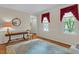 Bright living room boasting hardwood floors, stylish curtains, and natural light from the large windows at 6245 Hampton Ridge Rd, Raleigh, NC 27603