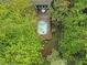 Aerial view of a charming in-ground pool with an adjacent deck surrounded by lush greenery at 6245 Hampton Ridge Rd, Raleigh, NC 27603