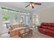 Sun-drenched living room featuring large windows, comfortable seating, and a view of the backyard at 6245 Hampton Ridge Rd, Raleigh, NC 27603