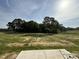 View of a partially grassed, partially sandy lot with treeline in the background at 63 Coharie Dr, Lillington, NC 27546