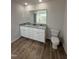 Modern bathroom featuring a double vanity with granite countertop and tile flooring at 63 Coharie Dr, Lillington, NC 27546