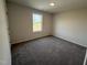 Carpeted bedroom with a window providing natural light and an outside view at 63 Coharie Dr, Lillington, NC 27546