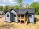 View of the back of a home with a wooden screened porch and stairs to the backyard at 648 Shawnee Dr, Louisburg, NC 27549