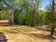 The backyard features a wooded lot with privacy and a storage shed at 648 Shawnee Dr, Louisburg, NC 27549