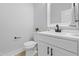 This bathroom features modern fixtures, with a neutral color scheme, including a vanity and toilet at 648 Shawnee Dr, Louisburg, NC 27549