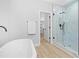 Primary bathroom with soaking tub, walk-in shower, and spacious closet at 648 Shawnee Dr, Louisburg, NC 27549
