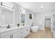 Primary bathroom with double vanities, soaking tub, and a walk-in shower at 648 Shawnee Dr, Louisburg, NC 27549