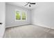 Bright bedroom with carpet floors, large window view of wooded area at 648 Shawnee Dr, Louisburg, NC 27549