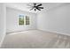 This bedroom features neutral walls and carpet, large window, and a modern ceiling fan at 648 Shawnee Dr, Louisburg, NC 27549