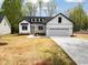 Charming two-story home with white siding, a two-car garage, and a well-manicured front yard at 648 Shawnee Dr, Louisburg, NC 27549