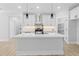 Beautiful white kitchen with large island, stainless appliances, and access to the walk-in pantry at 648 Shawnee Dr, Louisburg, NC 27549