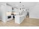 Open-concept kitchen with white cabinetry, stainless steel appliances, and a spacious center island at 648 Shawnee Dr, Louisburg, NC 27549