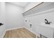 The laundry room boasts neutral paint, wood-look flooring, and a modern utility sink at 648 Shawnee Dr, Louisburg, NC 27549