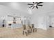 Open-concept living area with views of the kitchen, vaulted ceiling, and two modern chairs at 648 Shawnee Dr, Louisburg, NC 27549