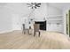 Bright and airy living room with a fireplace, built-in shelves, and hardwood floors at 648 Shawnee Dr, Louisburg, NC 27549