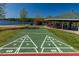 Lakeside community amenities featuring shuffleboard court with picnic tables and lake views at 648 Shawnee Dr, Louisburg, NC 27549