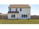 Home backyard featuring a fenced-in yard and a patio area with string lights at 76 Arlie Ln, Lillington, NC 27546