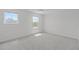 Bright bedroom with two windows and plush carpet at 76 Arlie Ln, Lillington, NC 27546