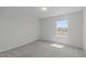 Bright bedroom with neutral carpet, white walls, and a window with a view at 76 Arlie Ln, Lillington, NC 27546