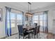 A dining room featuring a wood table set for six, complemented by bright, sunlit windows and stylish curtains at 76 Arlie Ln, Lillington, NC 27546