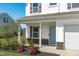 View of the home’s exterior, highlighting its covered front porch, manicured landscaping and modern design at 76 Arlie Ln, Lillington, NC 27546