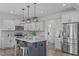 The kitchen features a large island, stainless steel appliances and white cabinets at 76 Arlie Ln, Lillington, NC 27546