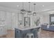 Open-concept kitchen featuring an island with seating, granite countertops, and stainless steel appliances at 76 Arlie Ln, Lillington, NC 27546