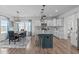 Modern kitchen with an open layout, island seating, and a bright dining space nearby at 76 Arlie Ln, Lillington, NC 27546