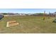 Spacious fenced yard with raised garden beds and backyard patio area with string lights at 76 Arlie Ln, Lillington, NC 27546