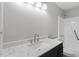Bathroom featuring a sleek vanity with a stone countertop, a modern faucet, and a shower-tub combo at 804 Harper Rd, Hillsborough, NC 27278
