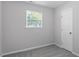 Neutral bedroom featuring plush carpet, a window, and a closet at 804 Harper Rd, Hillsborough, NC 27278