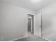 Neutral bedroom with carpet and light-colored walls with a glimpse of another room at 804 Harper Rd, Hillsborough, NC 27278