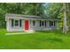 Charming single-story home with green lawn, surrounded by mature trees offering shade and privacy at 804 Harper Rd, Hillsborough, NC 27278