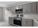 Updated kitchen with gray cabinetry, new appliances, and stylish backsplash at 804 Harper Rd, Hillsborough, NC 27278