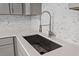 Close-up of kitchen sink with modern faucet and stylish backsplash at 804 Harper Rd, Hillsborough, NC 27278