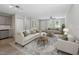 Bright living room featuring hardwood floors, neutral paint, plush seating, and natural light at 804 Harper Rd, Hillsborough, NC 27278