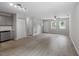 Open-concept living space with hardwood floors and modern kitchen, filled with natural light at 804 Harper Rd, Hillsborough, NC 27278
