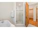 Bright bathroom featuring mosaic tiled floors, glass shower and a clawfoot soaking tub at 804 Old Mill Rd, Chapel Hill, NC 27514