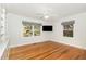 This comfortable bedroom features hardwood floors, a ceiling fan, and bright windows at 804 Old Mill Rd, Chapel Hill, NC 27514