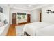 Bright bedroom features hardwood floors, recessed lights, ceiling fan, and window seat at 804 Old Mill Rd, Chapel Hill, NC 27514