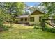 Charming home exterior complemented by verdant lawn and mature trees at 804 Old Mill Rd, Chapel Hill, NC 27514