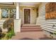 Inviting front porch with stained wood steps, stylish lighting, and an artisan wall hanging at 804 Old Mill Rd, Chapel Hill, NC 27514