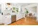 Well-lit kitchen features white cabinets, stainless steel appliances, and easy access to the dining room at 804 Old Mill Rd, Chapel Hill, NC 27514