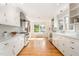 Bright and airy kitchen with white cabinets, stainless steel appliances, and hardwood floors at 804 Old Mill Rd, Chapel Hill, NC 27514