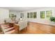 Bright living room featuring hardwood floors, neutral decor, and large windows that fill the space with natural light at 804 Old Mill Rd, Chapel Hill, NC 27514