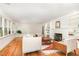 This living room features beautiful hardwood floors, a cozy fireplace, and large windows with an outdoor view at 804 Old Mill Rd, Chapel Hill, NC 27514