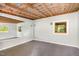 Versatile room with exposed ceiling, large mirror, and natural light at 804 Old Mill Rd, Chapel Hill, NC 27514