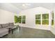 Sunlit sunroom offering vaulted ceiling, tile floor, large windows, and a comfortable seating area at 804 Old Mill Rd, Chapel Hill, NC 27514
